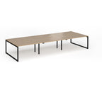Long back-to-back desk with wood-effect top and black metal legs on a white background