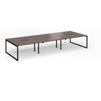 Long back-to-back desk with wood-effect top and black metal legs on a white background