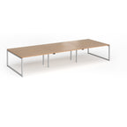 Long back-to-back desk with wood-effect top and silver metal legs on a white background