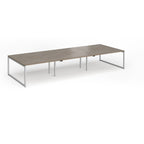 Long back-to-back desk with wood-effect top and silver metal legs on a white background