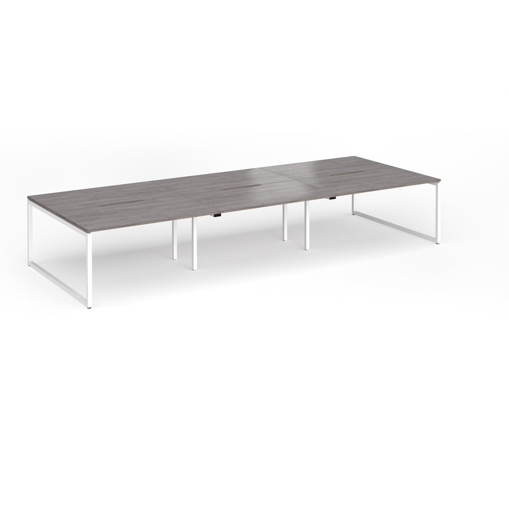 Long back-to-back desk with grey wood-effect top and white metal legs on a white background