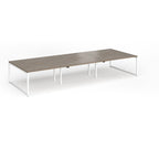 Long back-to-back desk with wood-effect top and white metal legs on a white background