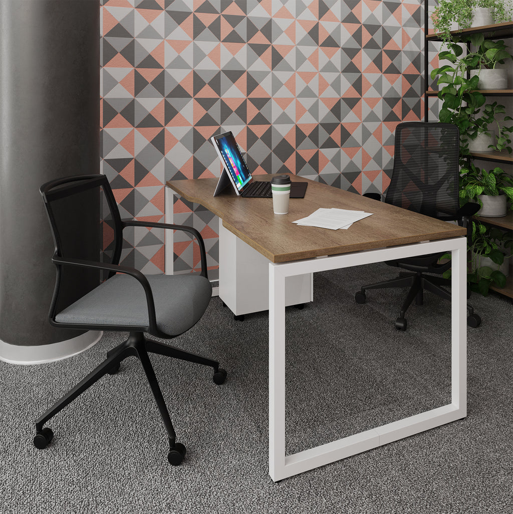 Modern office setup with a wooden desk, black office chairs, and geometric patterned wall.