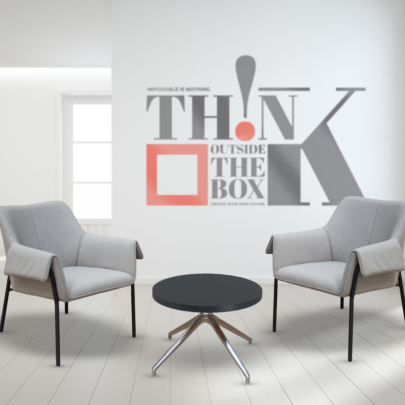 Two armchairs and a table with a wall with logo in the background