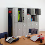Row of grey lockers with items inside, a table with various objects in front