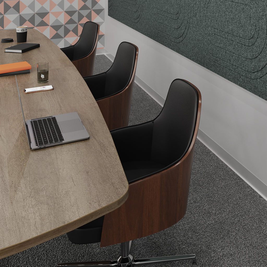 Modern meeting room scene with three swivel office chairs featuring dark wood frames and black upholstery, arranged around a light wood conference table with a laptop, notebook, and coffee cup.