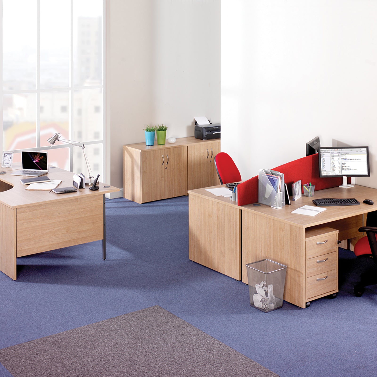 Modern office setup with wooden desks, chairs, and office equipment.
