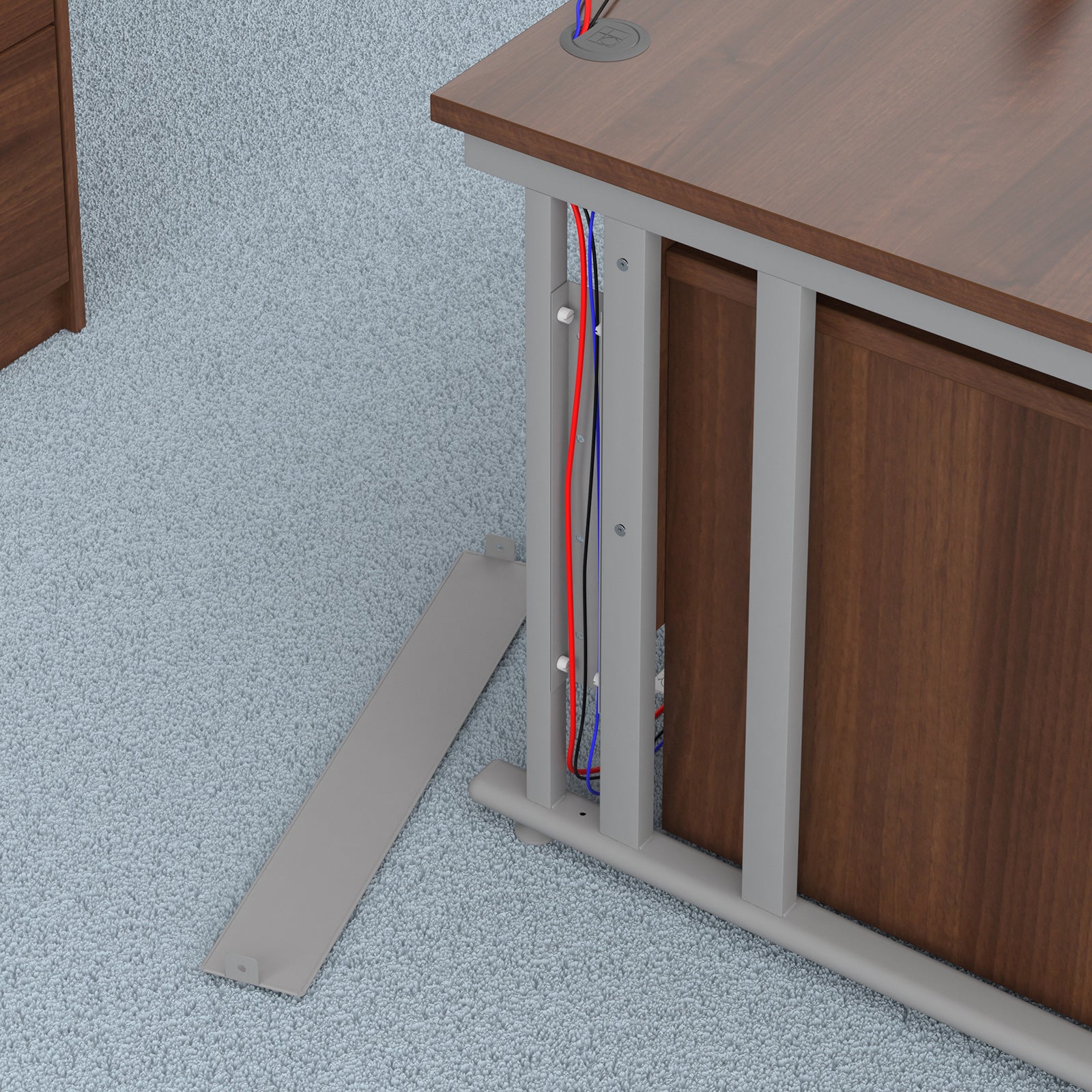 Wooden desk with exposed cables underneath on a light blue textured floor.