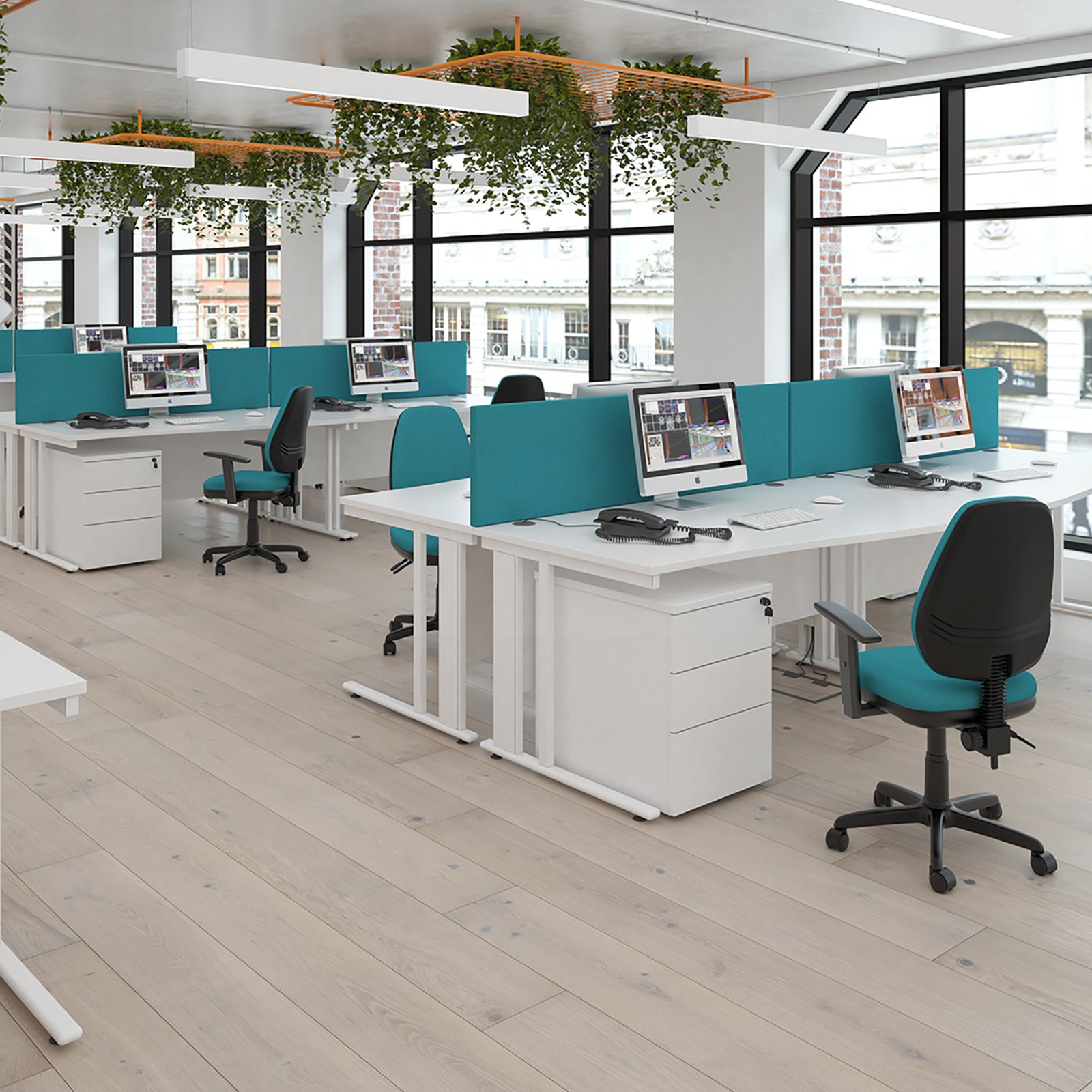 Modern office space with desks, chairs, and computer monitors.