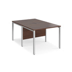 Back-to-back office desk with wood-effect top and silver metal frame on a white background