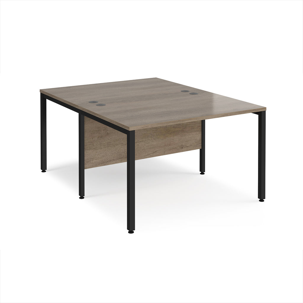 Back-to-back office desk with wood-effect top and black metal frame on a white background