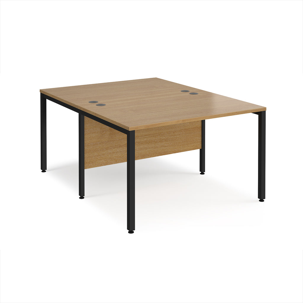 Back-to-back office desk with wood-effect top and black metal frame on a white background