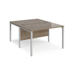 Back-to-back office desk with wood-effect top and silver metal frame on a white background
