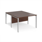 Back-to-back office desk with wood-effect top and silver metal frame on a white background