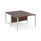 Back-to-back office desk with wood-effect top and white metal frame on a white background