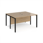 Back-to-back desk with wood-effect top and black metal frame on a white background