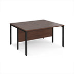 Back-to-back desk with wood-effect top and black metal frame on a white background
