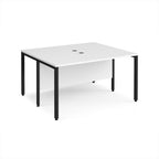 Back-to-back desk with white top and black metal frame on a white background