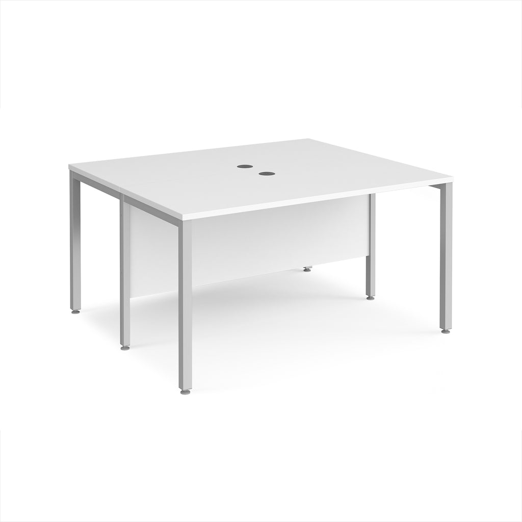 Back-to-back desk with white top and silver metal frame on a white background