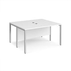 Back-to-back desk with white top and silver metal frame on a white background
