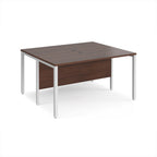 Back-to-back desk with wood-effect top and white metal frame on a white background