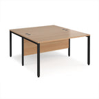 Back-to-back office desk with wood-effect top and black metal frame on a white background