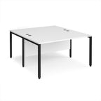 Back-to-back office desk with white top and black metal frame on a white background