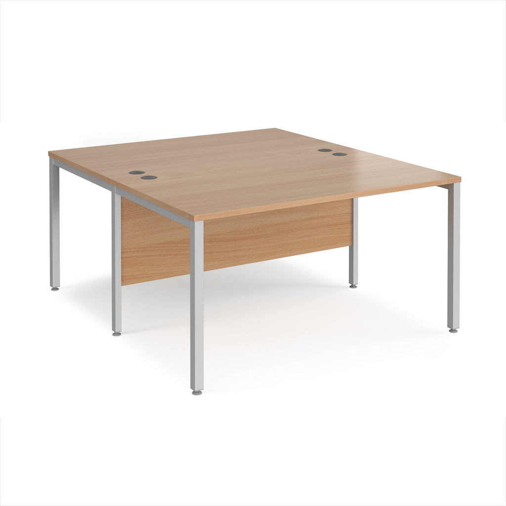 Back-to-back office desk with wood-effect top and silver metal frame on a white background
