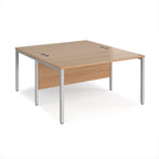 Back-to-back office desk with wood-effect top and silver metal frame on a white background