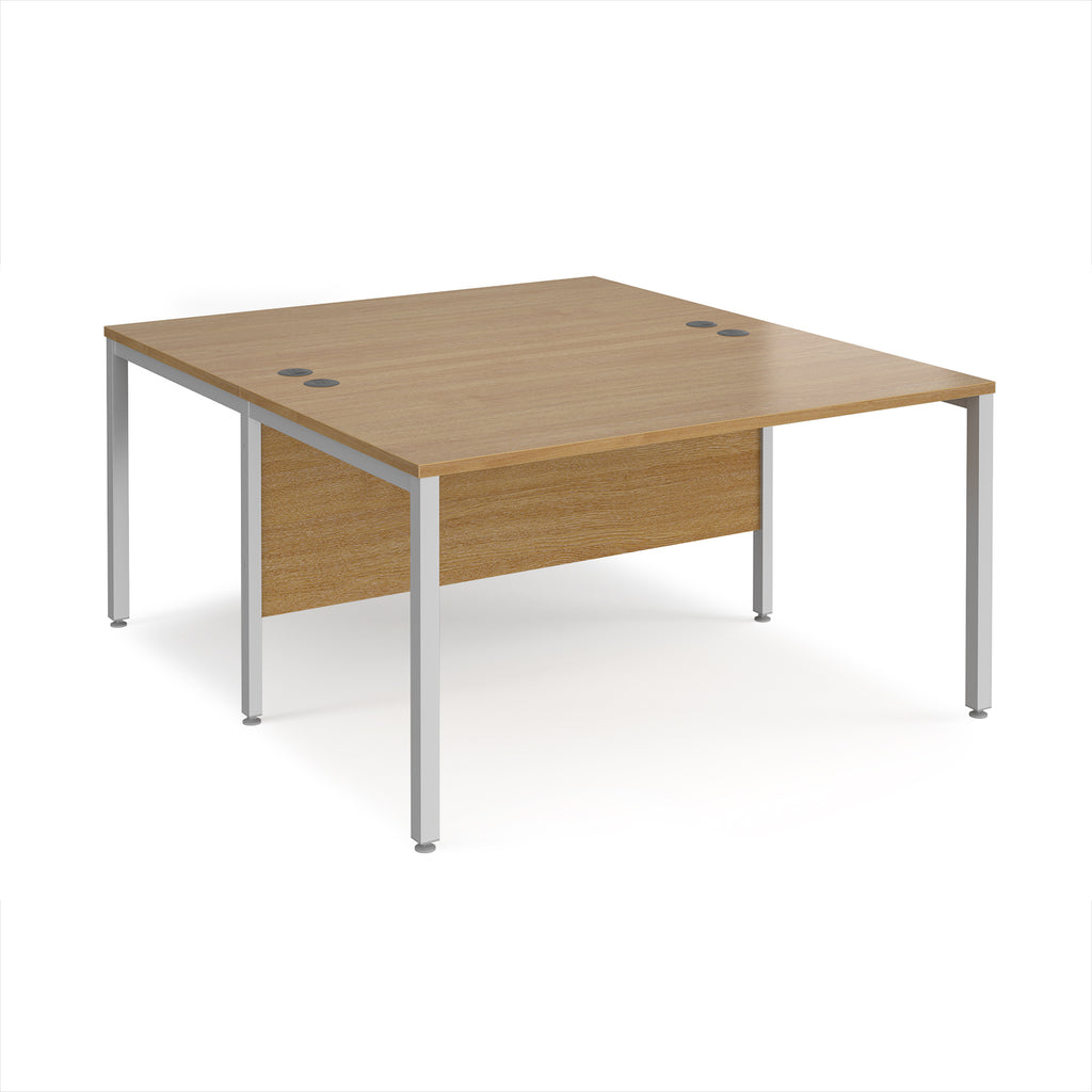 Back-to-back office desk with wood-effect top and silver metal frame on a white background