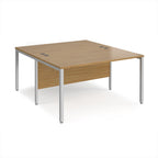 Back-to-back office desk with wood-effect top and silver metal frame on a white background