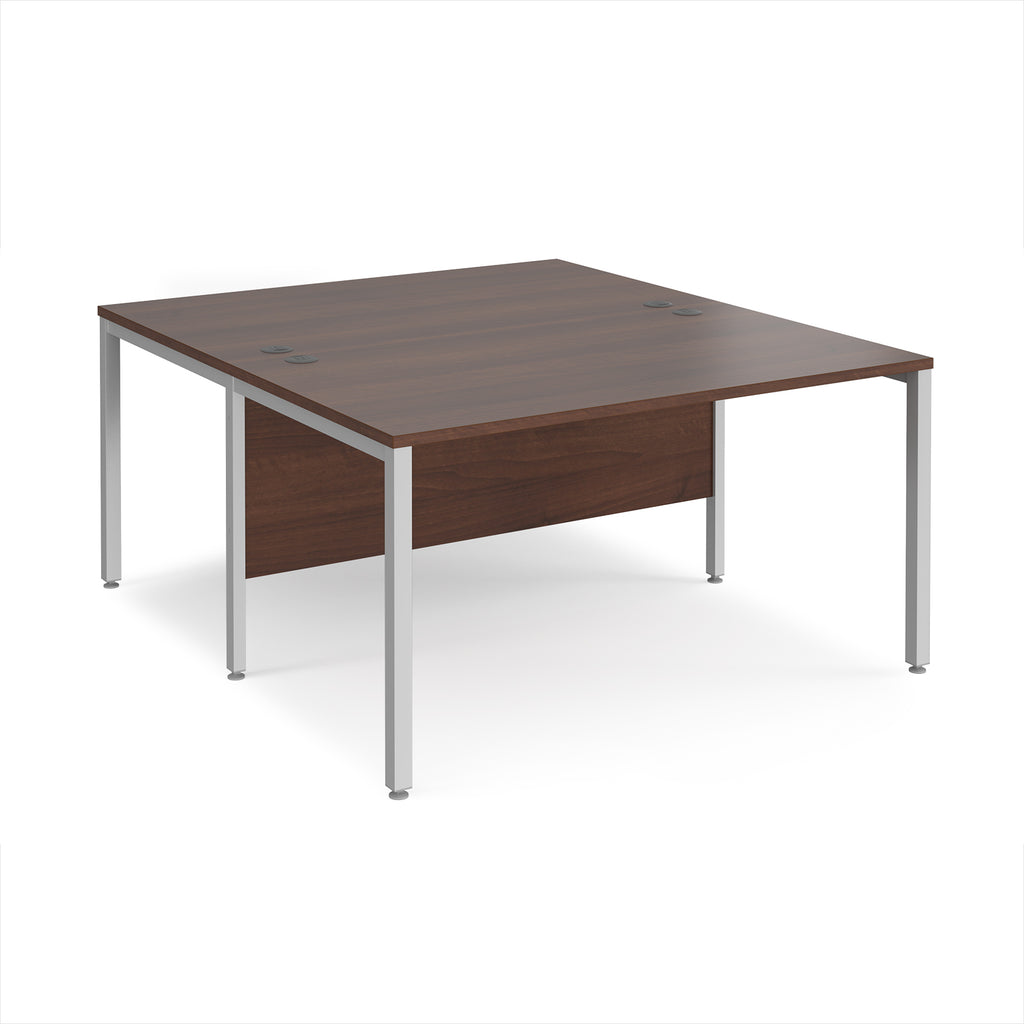 Back-to-back office desk with wood-effect top and silver metal frame on a white background