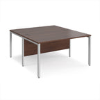 Back-to-back office desk with wood-effect top and silver metal frame on a white background