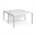 Back-to-back office desk with white top and silver metal frame on a white background