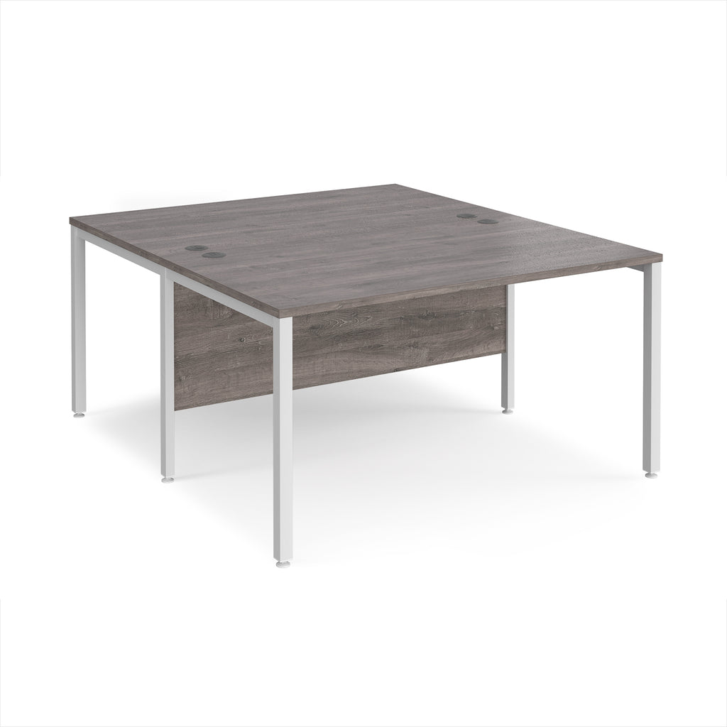 Back-to-back office desk with grey wood-effect top and white metal frame on a white background