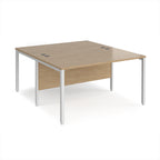 Back-to-back office desk with wood-effect top and white metal frame on a white background