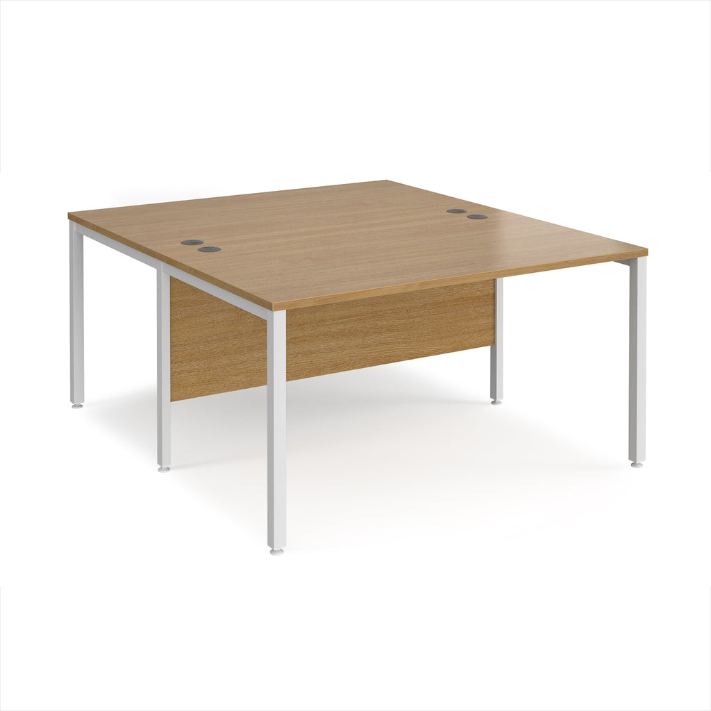 Back-to-back office desk with wood-effect top and white metal frame on a white background