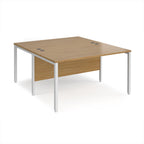 Back-to-back office desk with wood-effect top and white metal frame on a white background