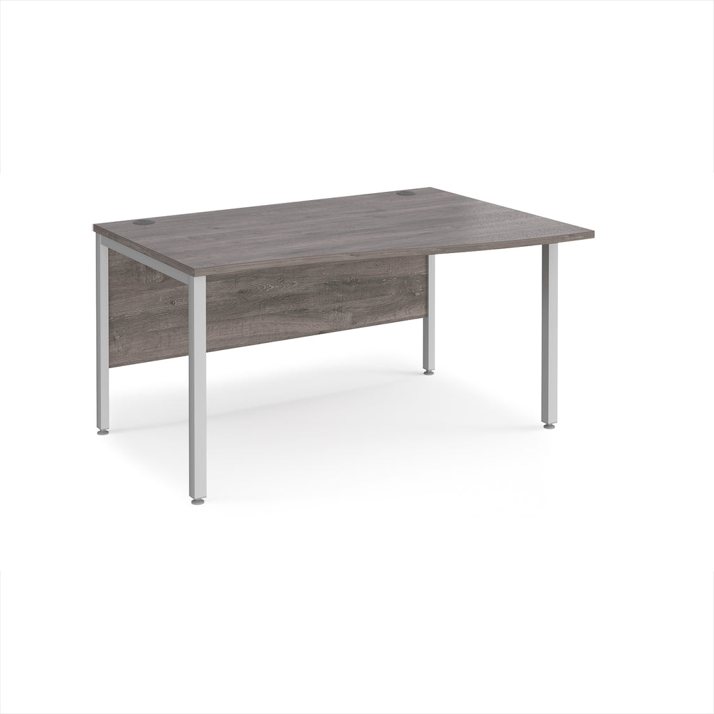 Office desk with wave grey wood-effect top and silver metal legs on a white background