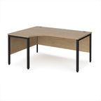 Ergonomic office desk with wood-effect top and black metal frame on a white background