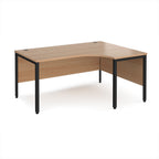Ergonomic office desk with wood-effect top and black metal frame on a white background