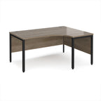 Ergonomic office desk with wood-effect top and black metal frame on a white background