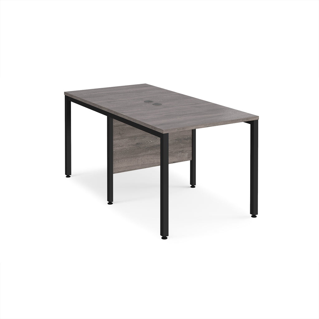 Back-to-back office desk with grey wood-effect top and black metal frame on a white background