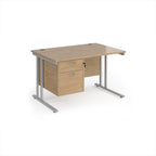 Wooden office desk with silver metal legs and fixed pedestal on a white background