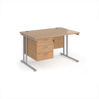 Wooden office desk with silver metal legs and fixed pedestal on a white background