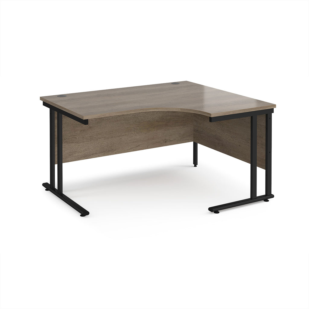 L-shaped desk with wooden surface and black metal legs on a white background
