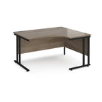 L-shaped desk with wooden surface and black metal legs on a white background