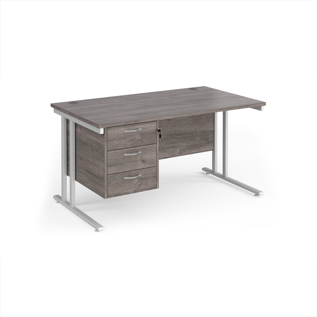 Wooden desk with metal legs and three drawers on a white background