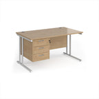 Wooden office desk with metal legs and three drawers on a white background
