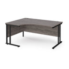 Corner office desk with wooden surface and black metal legs on a white background